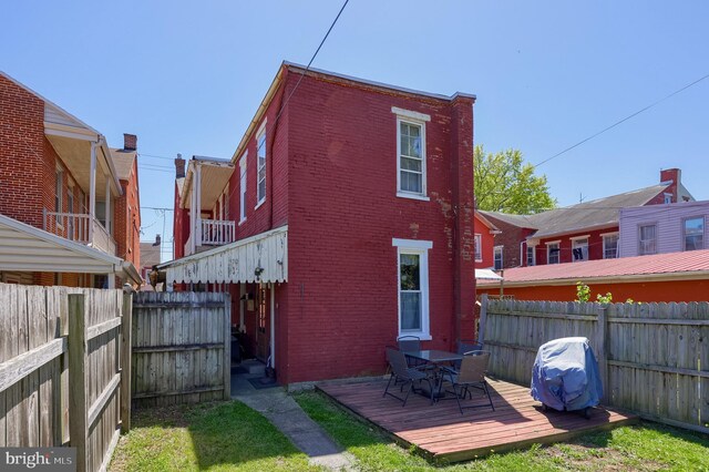 731 Locust St, Columbia, PA 17512 - back of property with brick siding, a wooden deck, a fenced backyard, and outdoor dining area