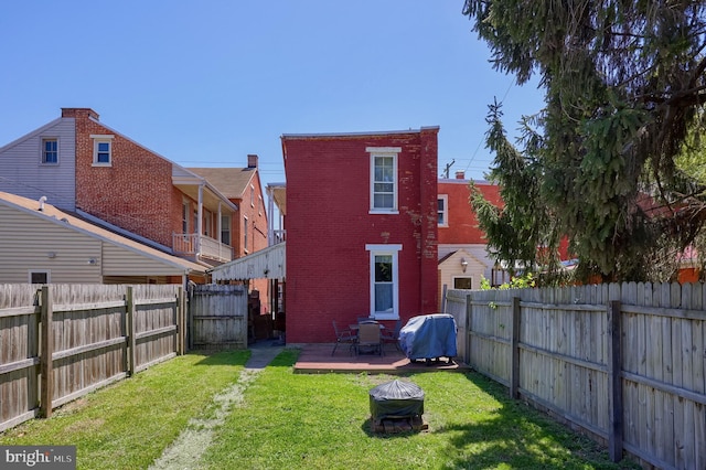 731 Locust St, Columbia, PA 17512 - back of property featuring a yard, brick siding, and a fenced backyard