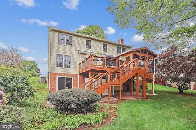 rear view of house with a chimney, a lawn, a wooden deck, stairway, and central air condition unit