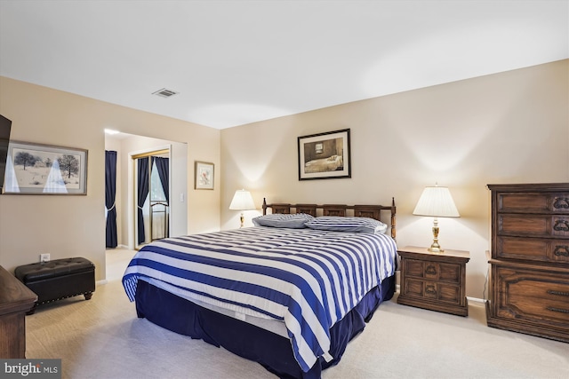 bedroom with baseboards, visible vents, carpet, and a closet