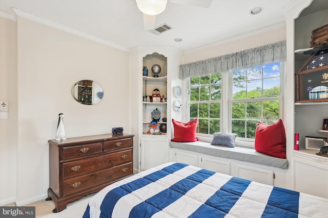 bedroom featuring crown molding, baseboards, visible vents, and carpet