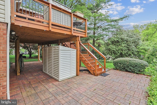 view of patio / terrace with a wooden deck and stairway