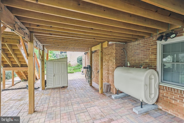 view of patio / terrace featuring a storage unit and heating fuel