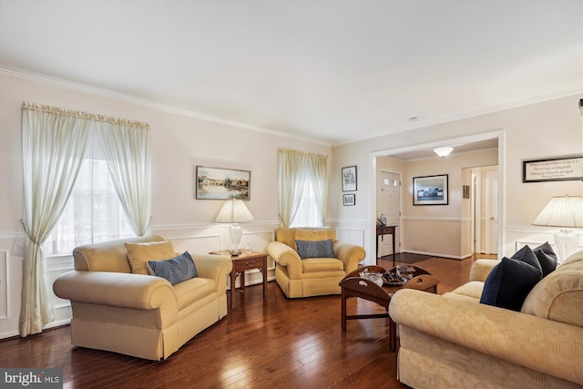 living area featuring crown molding, plenty of natural light, and a wainscoted wall