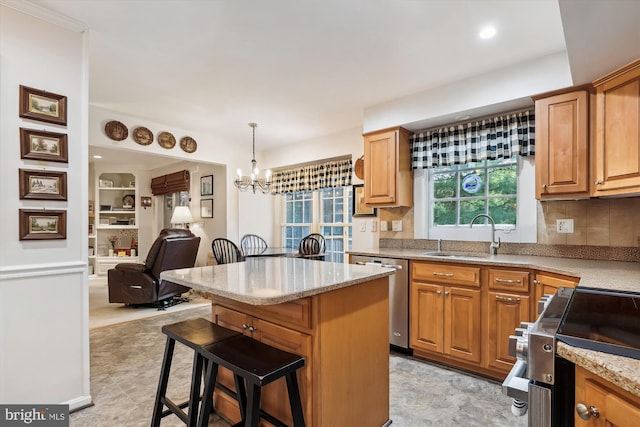 kitchen with appliances with stainless steel finishes, light stone counters, a sink, a center island, and tasteful backsplash