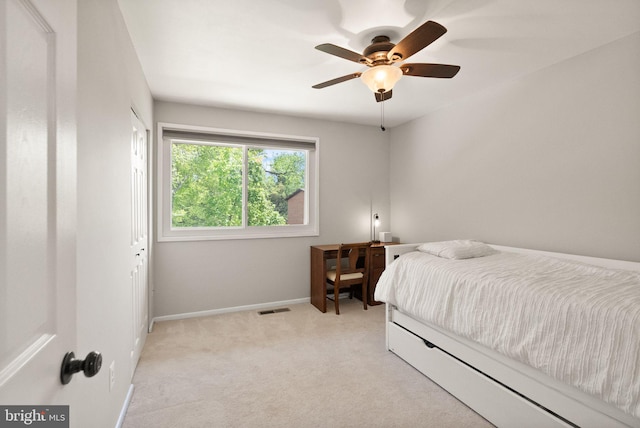 bedroom with baseboards, ceiling fan, light carpet, and visible vents