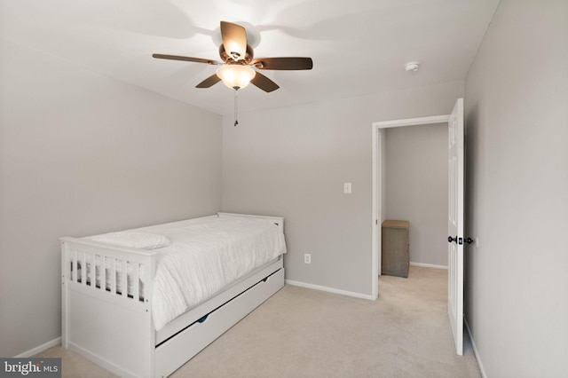bedroom with baseboards, ceiling fan, and light colored carpet