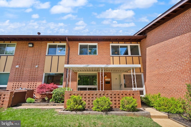 view of front facade with a porch and brick siding