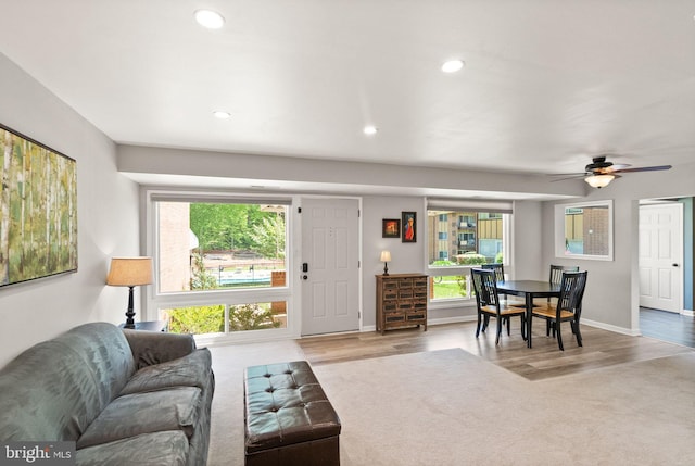 living area with baseboards, ceiling fan, recessed lighting, and wood finished floors