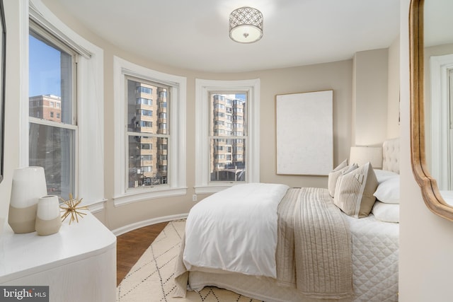 bedroom featuring baseboards and wood finished floors