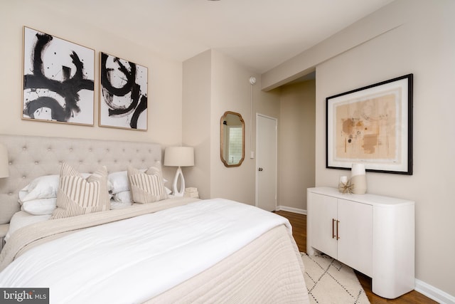 bedroom featuring light wood-style floors and baseboards