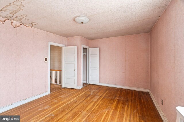 unfurnished bedroom featuring baseboards and hardwood / wood-style floors