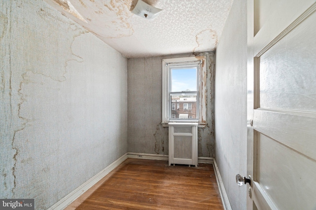 empty room featuring baseboards and wood finished floors