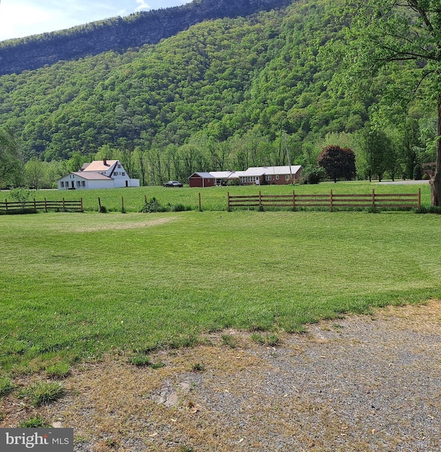 exterior space featuring a rural view and a forest view
