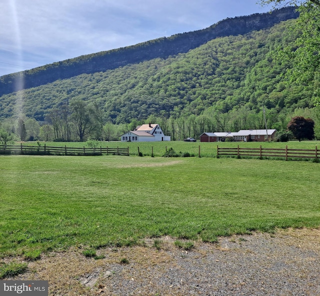 view of mountain feature with a view of trees and a rural view