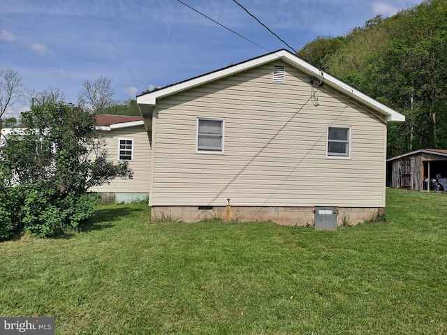 view of home's exterior featuring a lawn and crawl space