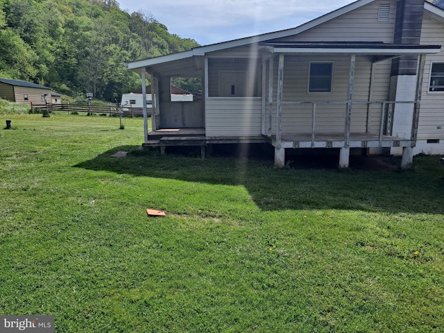 exterior space featuring a lawn and a wooden deck