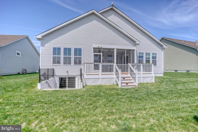 back of property with a lawn, a sunroom, and a deck