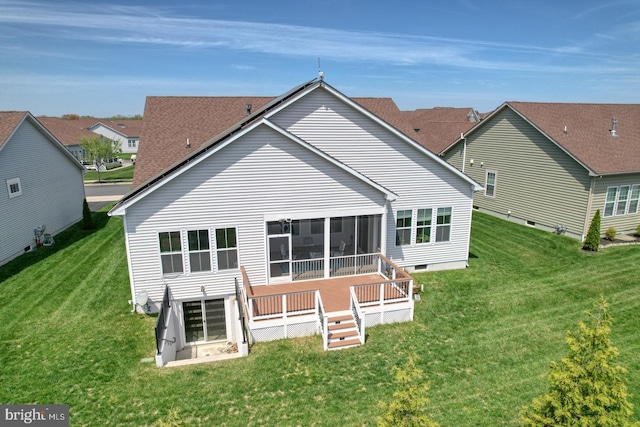 rear view of house featuring a yard and a wooden deck