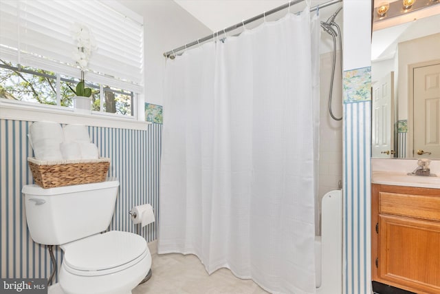 bathroom featuring toilet, a shower with curtain, and vanity