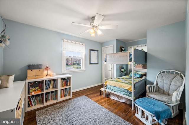 bedroom with a ceiling fan, baseboards, and wood finished floors