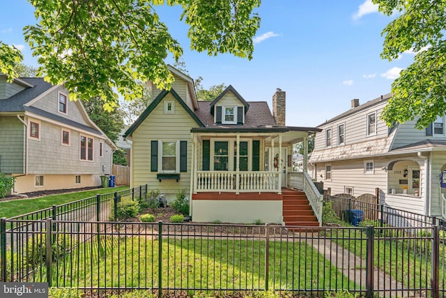 bungalow-style house featuring covered porch, a chimney, stairs, and a front yard