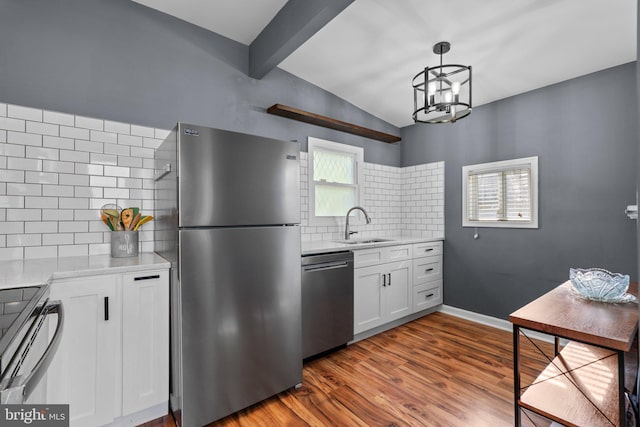 5310 Brabant Rd, Baltimore, MD 21229 - kitchen with appliances with stainless steel finishes, a sink, decorative backsplash, lofted ceiling, and white cabinets