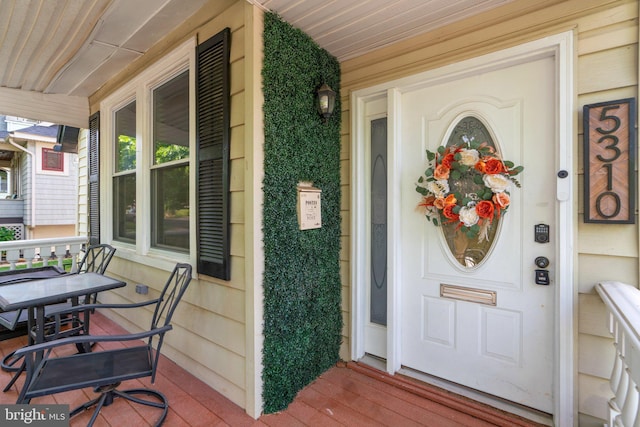 doorway to property featuring covered porch