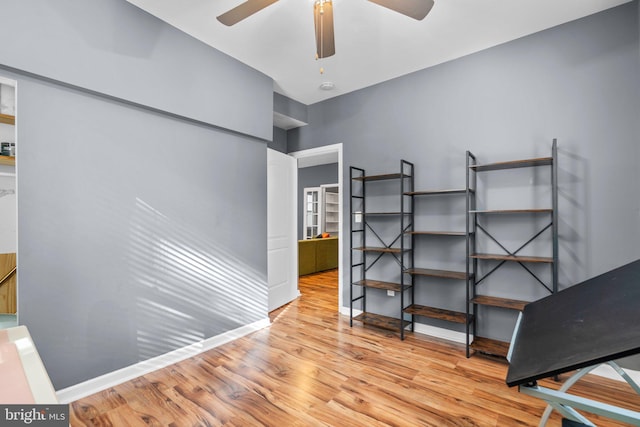 bedroom featuring baseboards and wood finished floors