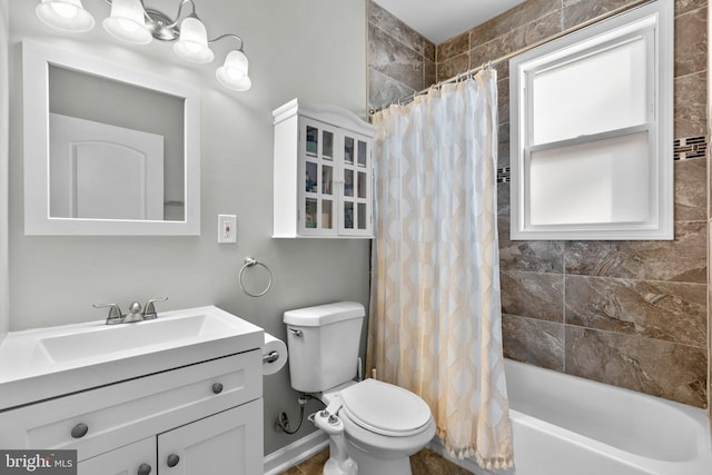 full bath with vanity, shower / bath combo with shower curtain, and toilet
