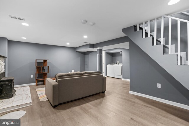 5310 Brabant Rd, Baltimore, MD 21229 - living area featuring baseboards, washing machine and dryer, wood finished floors, stairs, and recessed lighting