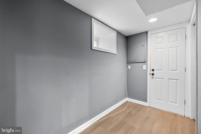 doorway with light wood-style floors, baseboards, and recessed lighting