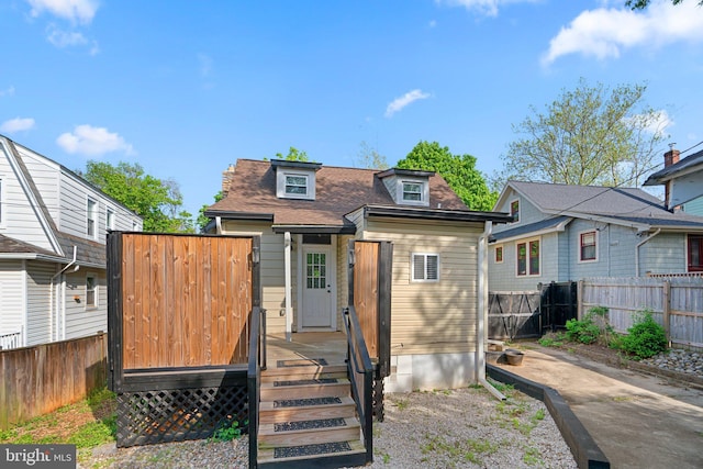 5310 Brabant Rd, Baltimore, MD 21229 - rear view of house with fence, a deck, and a shingled roof