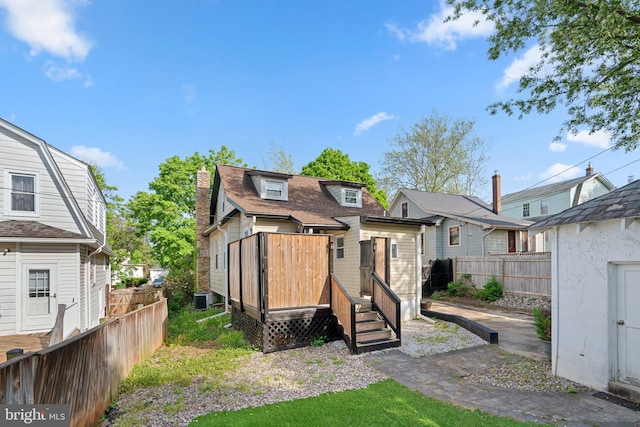 rear view of house with fence and a residential view