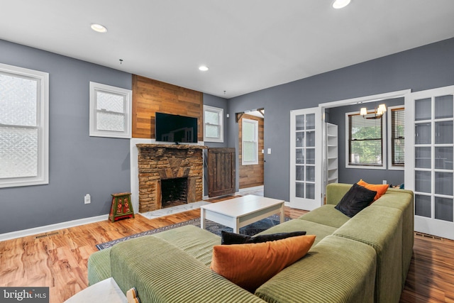 5310 Brabant Rd, Baltimore, MD 21229 - living area with recessed lighting, a fireplace, a chandelier, wood finished floors, and baseboards