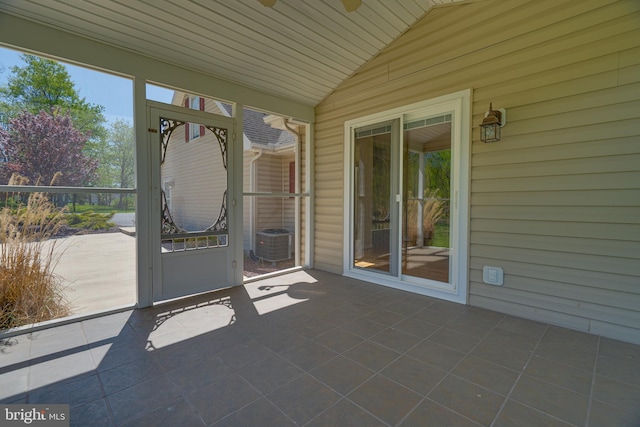 unfurnished sunroom featuring ceiling fan