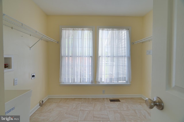 laundry room featuring a healthy amount of sunlight, washer hookup, hookup for an electric dryer, laundry area, and visible vents
