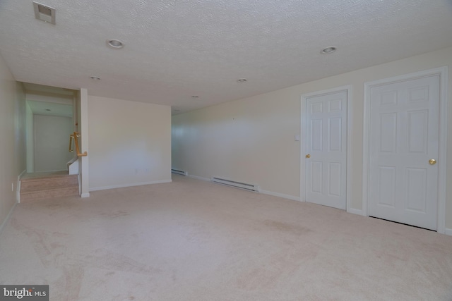 spare room with visible vents, a baseboard radiator, and carpet