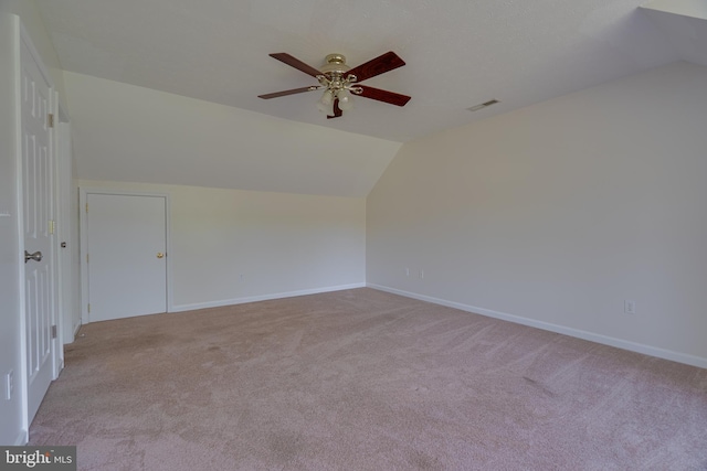 bonus room featuring carpet flooring, ceiling fan, baseboards, lofted ceiling, and visible vents