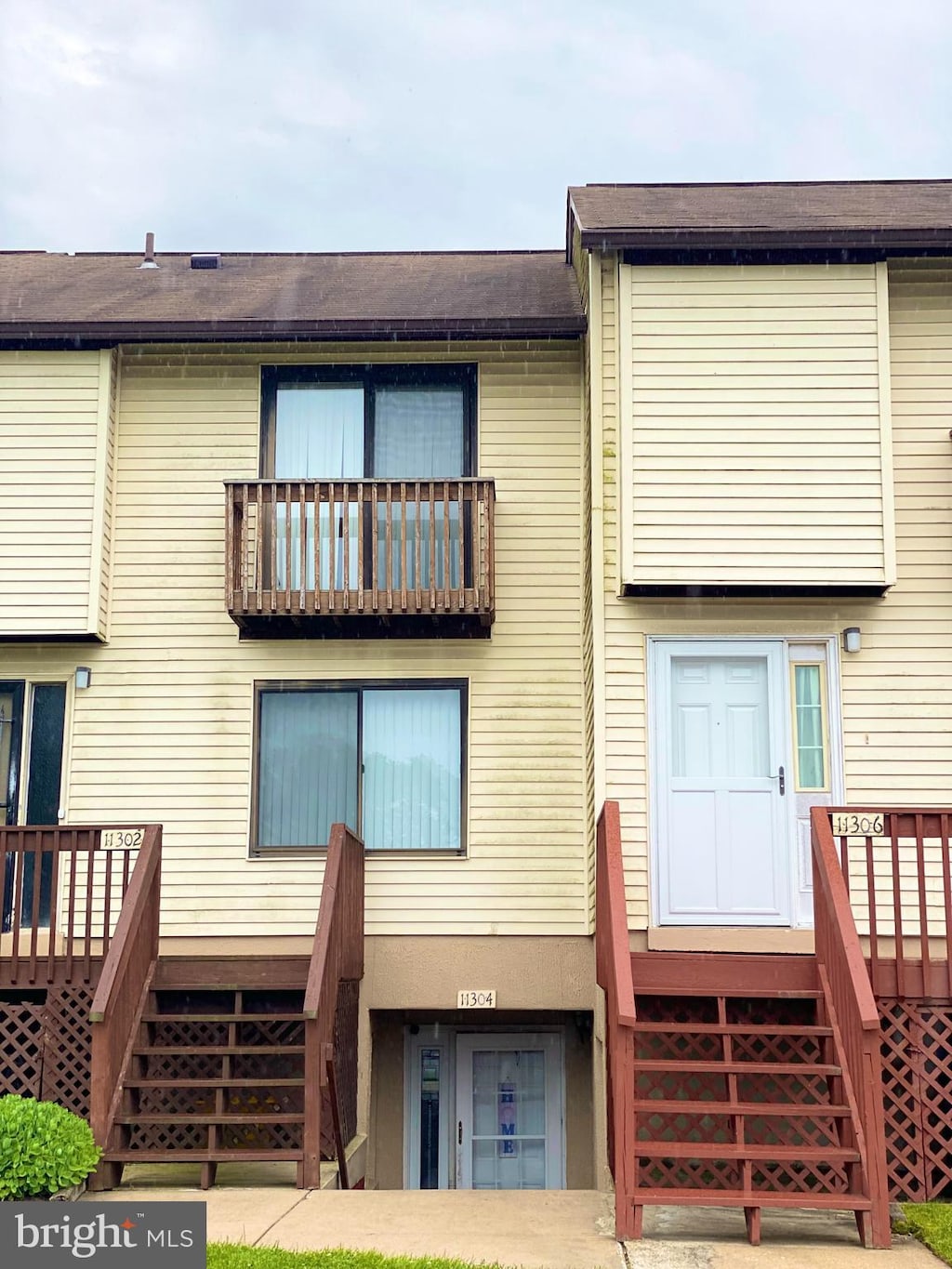 back of property featuring a wooden deck and stairway