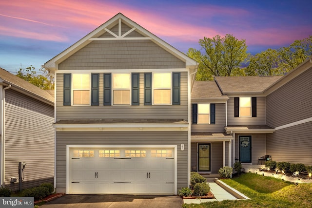 view of front of property with a garage and aphalt driveway