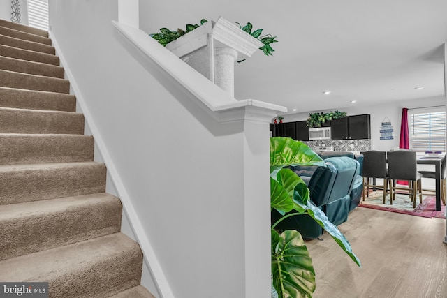 staircase featuring recessed lighting and wood finished floors