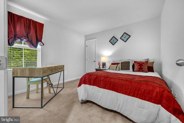 carpeted bedroom featuring baseboards