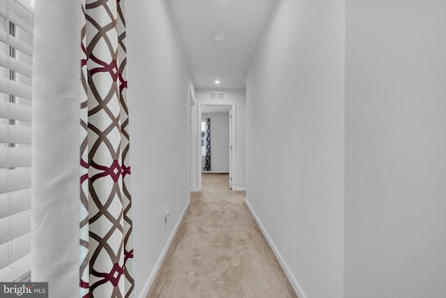 hallway with recessed lighting, baseboards, visible vents, and light carpet