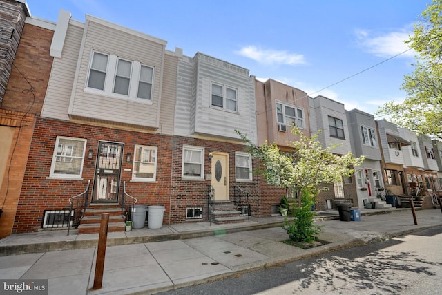 multi unit property featuring brick siding, a residential view, and entry steps
