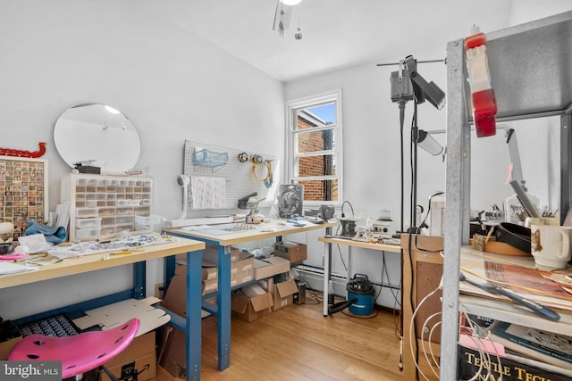 interior space with a workshop area and wood finished floors