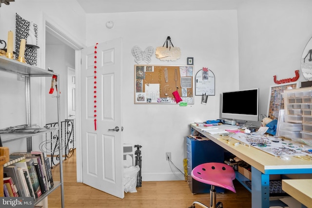 office featuring baseboards and wood finished floors