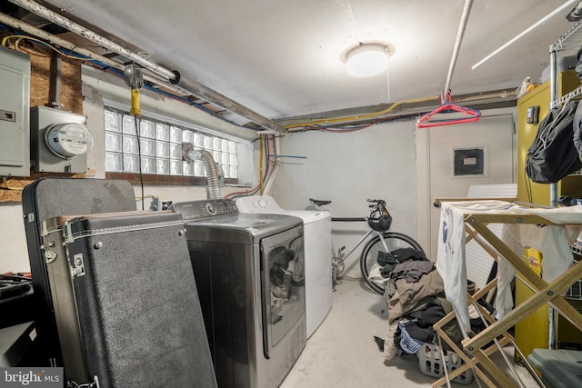 washroom featuring laundry area, washing machine and dryer, and electric panel