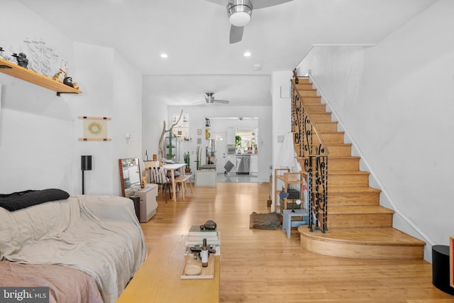 living area featuring stairs, recessed lighting, ceiling fan, and light wood-style flooring