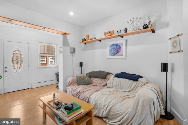 living room featuring recessed lighting, light wood-style flooring, and baseboard heating